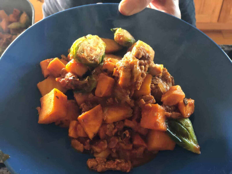 Vegan Sausage Goulash on a blue plate from Green Smoothie Girl