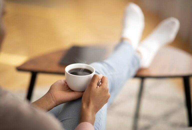 picture of a woman holding a cup of coffee from Green Smoothie Girl's "9 Healthy, Satisfying Bone Broth Beverages to Warm You Up"