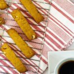 slices of biscotti on a tray over a red and white cloth from Green Smoothie Girl's "Chocolate Pumpkin High-Protein Biscotti Recipe"