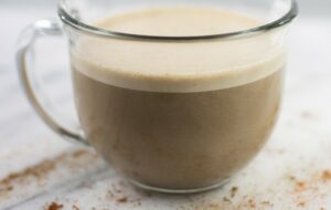 Hot chocolate in a clear mug from Green Smoothie Girl's "Mexican Hot Chocolate Protein Elixir"
