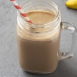 image of a smoothie in a glass mug with a red and white smoothie on a gray background from GreenSmoothieGirl's recipe "Chocolatey Mint Coffee Smoothie"