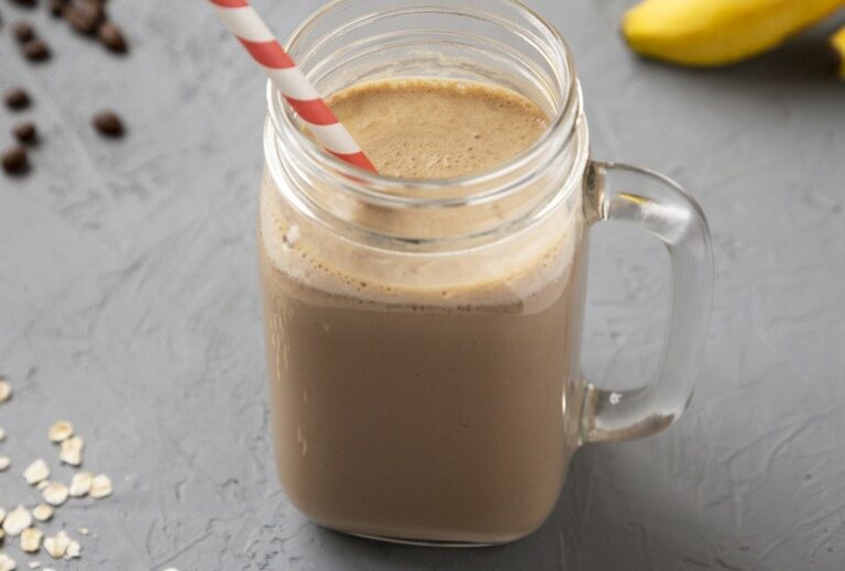 image of a smoothie in a glass mug with a red and white smoothie on a gray background from GreenSmoothieGirl's recipe "Chocolatey Mint Coffee Smoothie"