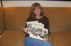 Theresa holding a few of her books