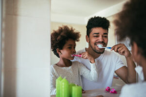 African american family washing teeth in the bathroom.